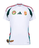 Hungary - 2024/2025 - Jersey Hungary - Uniform alternate Hungary - Adidas Hungary - Diseño clásico - White, red and green - Competiciones internacionales - Patrones geométricos - Escudo nacional - Cuello in V - Escudo de la federación húngara - Logo de Adidas - Pants blancos - Socks rojas - Tradición - Innovación - Identidad - Tecnologías avanzadas - Rendimiento.